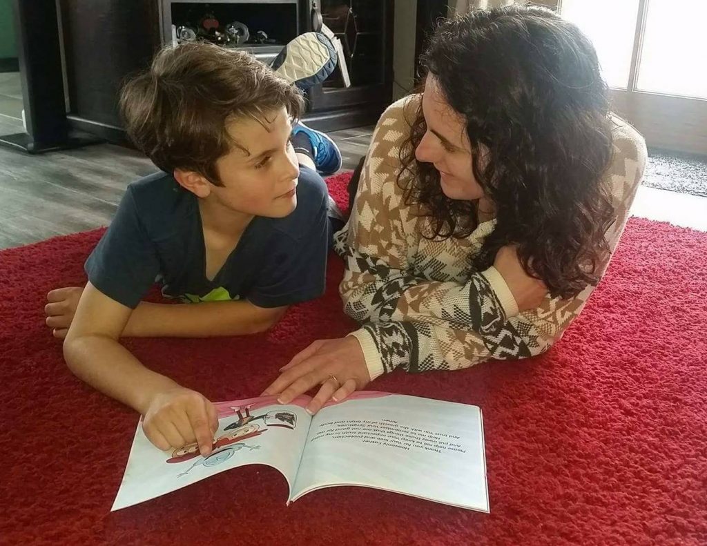 Emma reads the book with her son