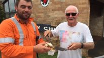 Harvey Weir, right, serves breakfast to Rohan Myers at Wesley Castle Hill Uniting Church.