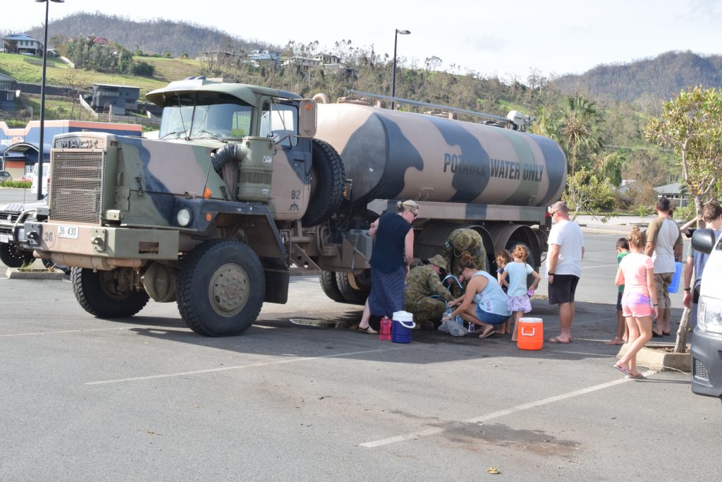 Airlie Beach residents line up for fresh water in the days following Cyclone Debbie