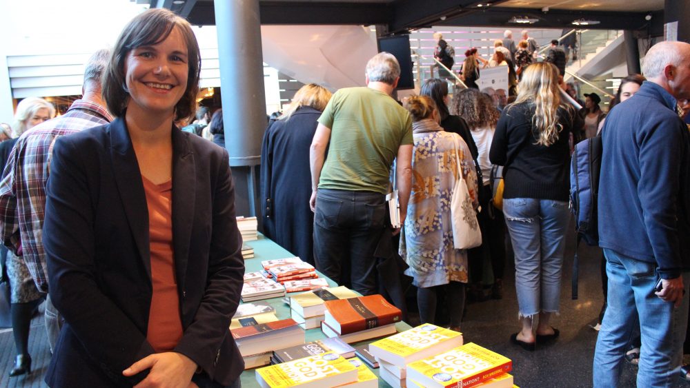 Historian Meredith Lake with her book, The Bible Down Under, and other Christian books, including the Bible, at Sydney Writers Festival.