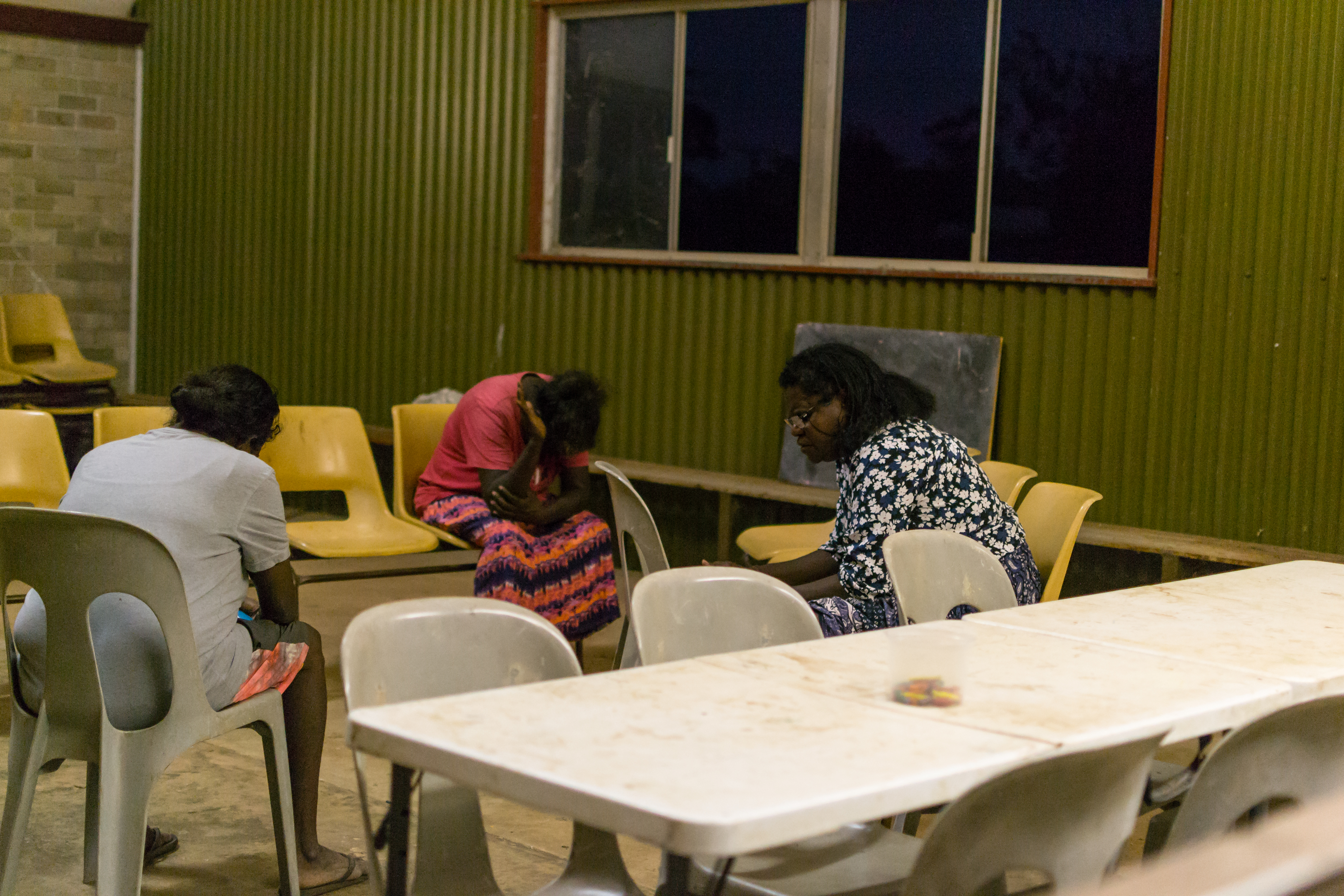 Women in the community pray for the kids while they attend Kids Club, Barunga