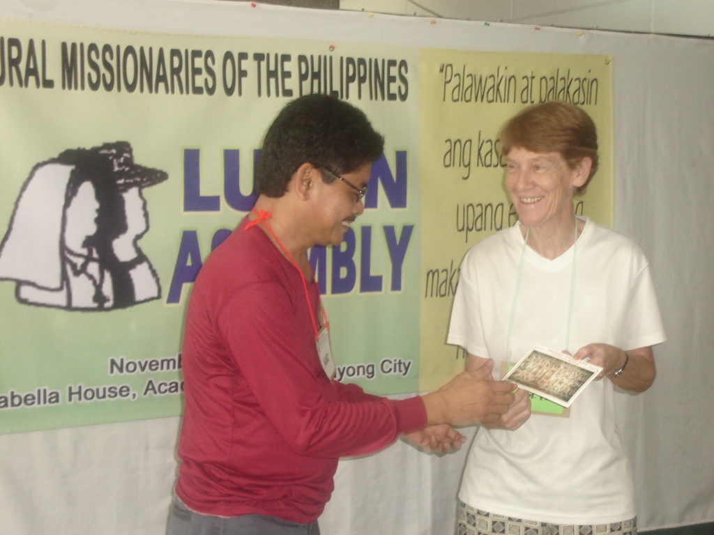 Receiving an award from a farmer at a Rural Missionaries meeting.