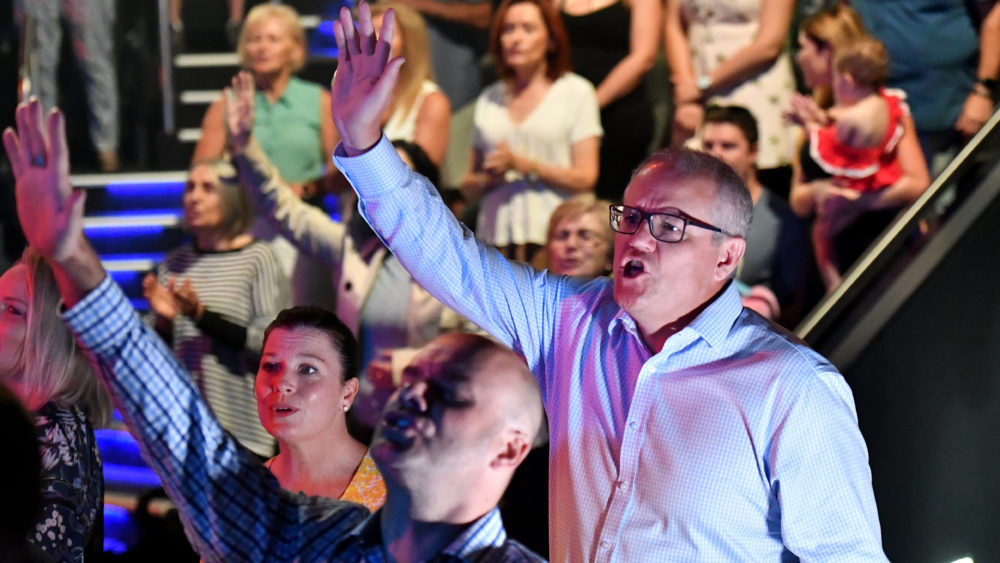 Prime Minister Scott Morrison and wife Jenny sing during an Easter Sunday service at his Horizon Church at Sutherland in Sydney, Sunday, April 21, 2019.