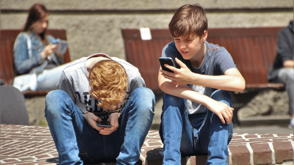 Boys Looking at mobile phones