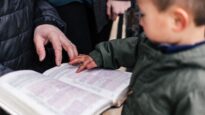 Little boy reading the Bible
