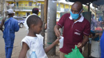 Girl with African Enterprise staffer in Kenya